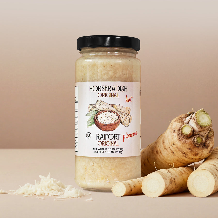 Jar of horseradish Original taste , surrounded by fresh horseradish roots on a beige background.